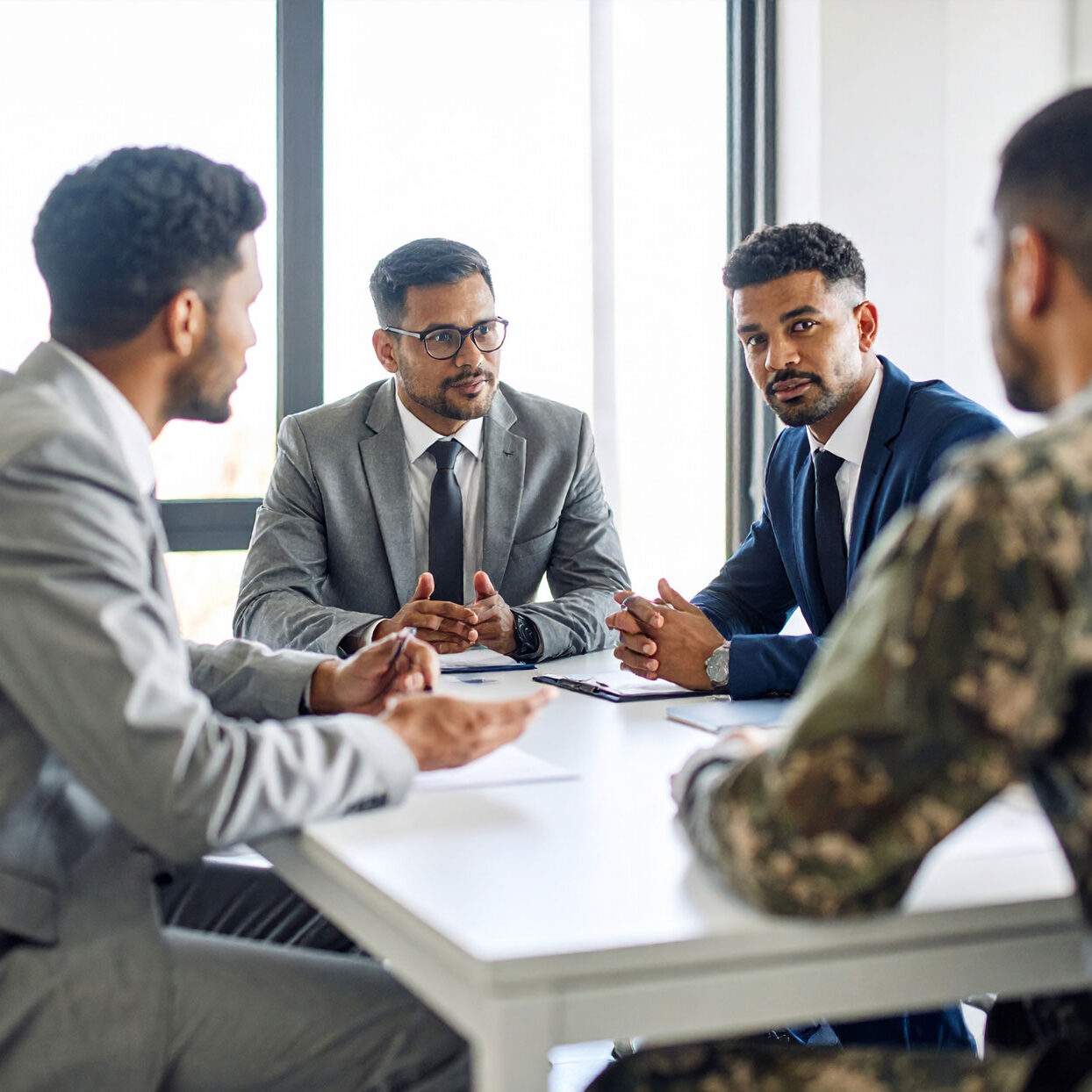 business-meeting-between-business-men-and-military-personel,-seating-at-a-conference